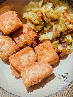 A picture of Egg coated Tofu (Awara) and stir fried cabbage sauce.