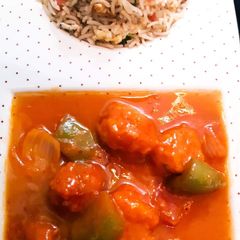 A picture of Chicken Shashlik with Vegetable fried Rice.