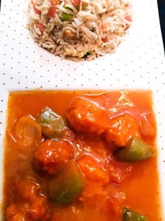 A picture of Chicken Shashlik with Vegetable fried Rice.
