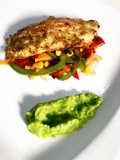 Deep fried fish fillet on a bed of sautéed vegetables & pea purée