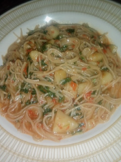 A picture of Spaghetti Jollof with Irish Potatoes.