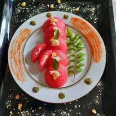A picture of Stuffed Oats Beetroot Idli.