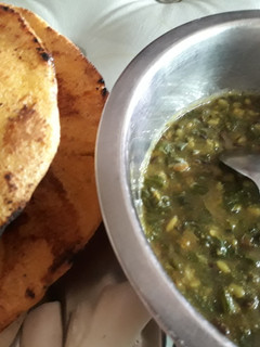 A picture of Palak ka saag with makki ki roti and mooli ki sabzi.