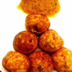 A picture of Adai kuzhi paniyaram with tomato-onion chutney.