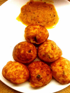 A picture of Adai kuzhi paniyaram with tomato-onion chutney.