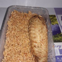 A picture of Home cooked jollof rice with fried Turkey.