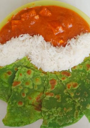 A picture of Paneer Butter Masala with Rice and Palak Paratha.