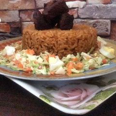 A picture of Beef Jollof rice with coleslaw.