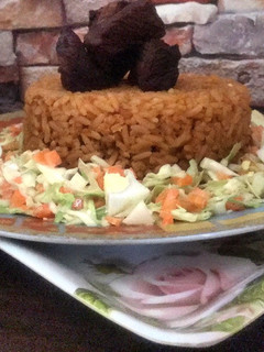 A picture of Beef Jollof rice with coleslaw.
