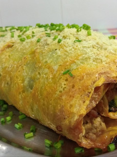 Una foto de Rollo de patata, carne y espinacas