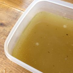 A picture of Chicken stock with leftover chicken bones.