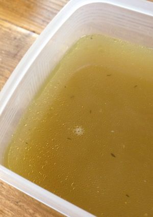 A picture of Chicken stock with leftover chicken bones.