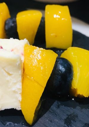 A picture of Fruit and cheese sticks.