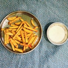 A picture of French Fries And Cheese Sauce.