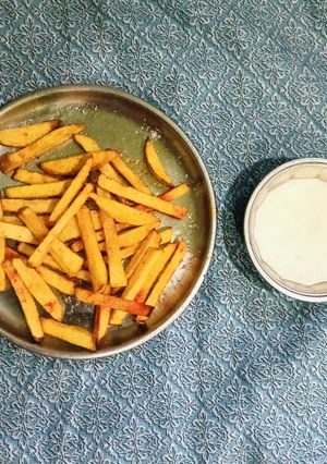 A picture of French Fries And Cheese Sauce.
