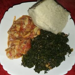 A picture of Mushroom, kales and ugali.