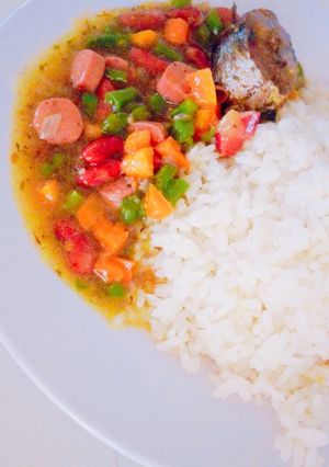 A picture of White rice and veggies sauce.