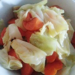 A picture of Cabbage with carrot and fish cake.