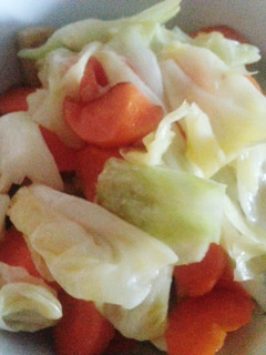 A picture of Cabbage with carrot and fish cake.