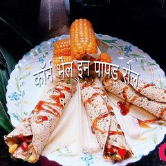 A picture of Corn bhel in papad roll.