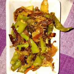 A picture of Fried chilli with onion and raw mango.