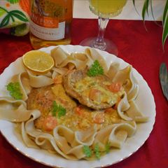A picture of Pork chops resting on creamy goodies.
