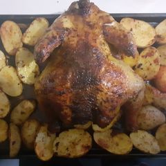 A picture of Roasted chicken with potatoes.