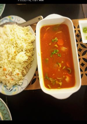 A picture of Chicken manchurian with fried rice.