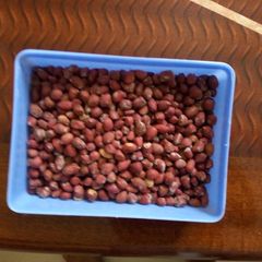 A picture of Roasted ground nuts in a salted pan.