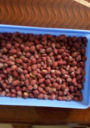 A picture of Roasted ground nuts in a salted pan.