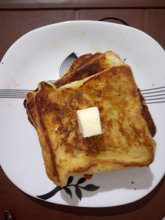A picture of French toast with butter.