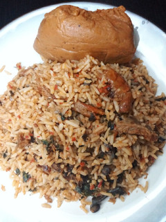 A picture of Local jollof rice with moimoi.
