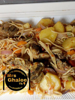 A picture of Jollof sphagetti with irish and meat.