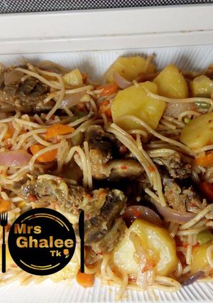 A picture of Jollof sphagetti with irish and meat.