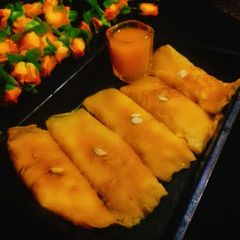 A picture of Taal Patishapta (Stuffed Palm crepes).