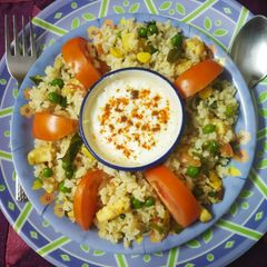 A picture of Colourful healthy rice with lots of paneer, Corn & vegetables.