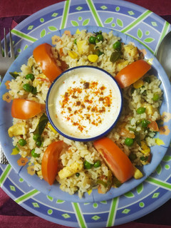 A picture of Colourful healthy rice with lots of paneer, Corn & vegetables.