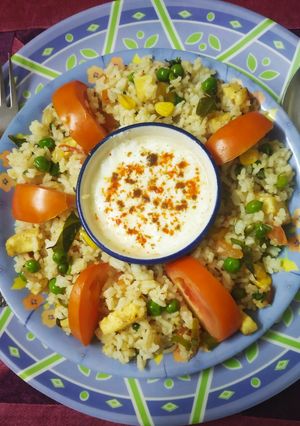 A picture of Colourful healthy rice with lots of paneer, Corn & vegetables.