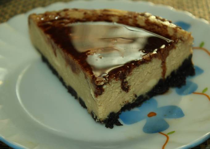 Coffee and rum flavored Cheesecake with an Oreo Crust and chocolate sauce topping