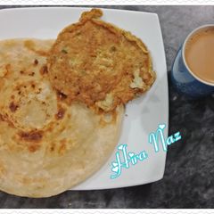 A picture of Egg With Lachaay Dar Paratha and Tea.
