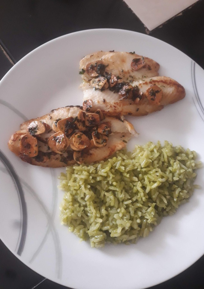 Una foto de Pescado al mojo de ajo con arroz verde