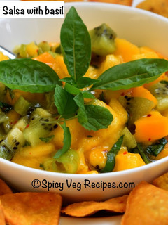 A picture of Mango Kiwi salsa with basil .