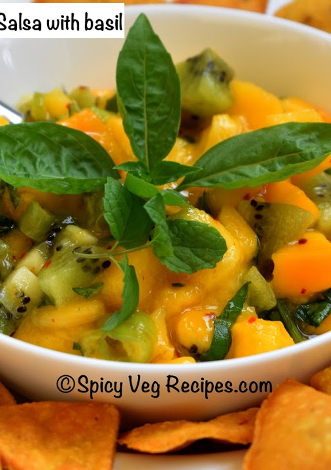 A picture of Mango Kiwi salsa with basil .