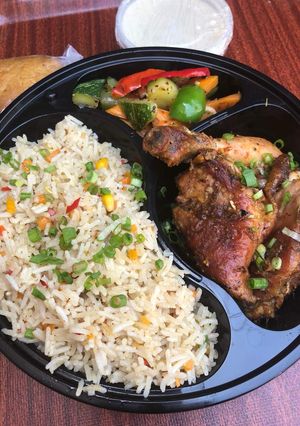 A picture of Chinese fried rice and grilled chicken.