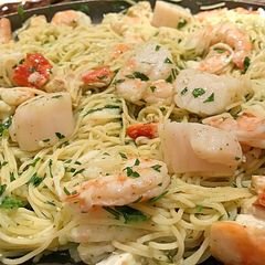 A picture of Poached shrimp and scallop pasta in beurre blanc.