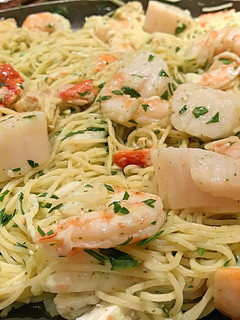 A picture of Poached shrimp and scallop pasta in beurre blanc.