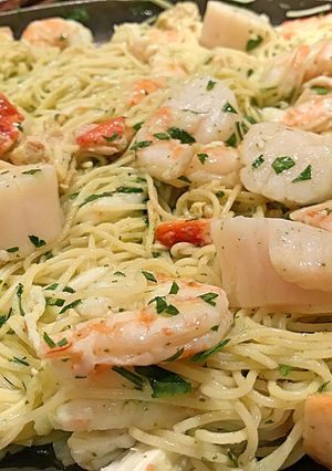 A picture of Poached shrimp and scallop pasta in beurre blanc.