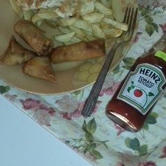 A picture of Chips,fried egg n samosa.