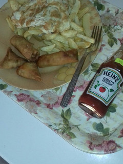 A picture of Chips,fried egg n samosa.