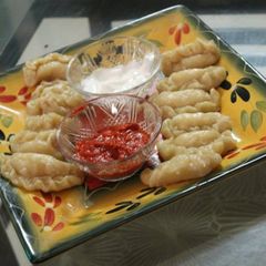 A picture of Vegetable momos with red chilli chutney and mayonnaise.